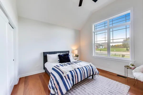 a bedroom with a bed and wooden floor