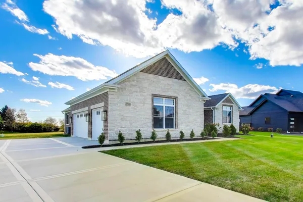 a front view of house with yard and green space