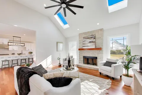 a living room with furniture fireplace and dining table