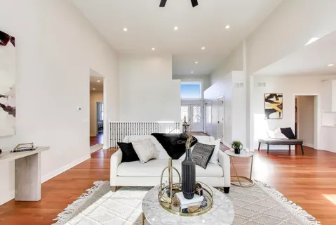 a living room with furniture and wooden floor