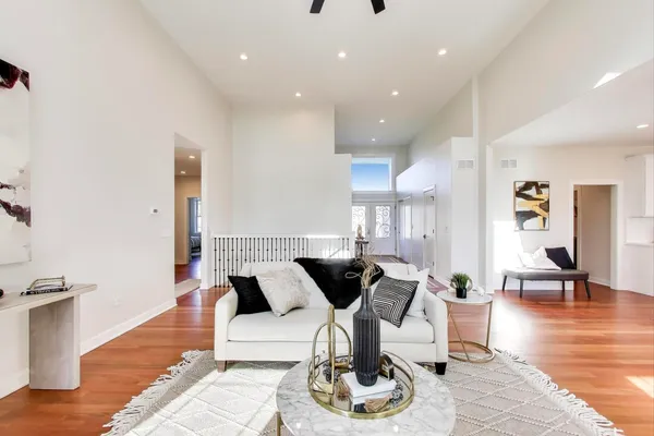 a living room with furniture and wooden floor