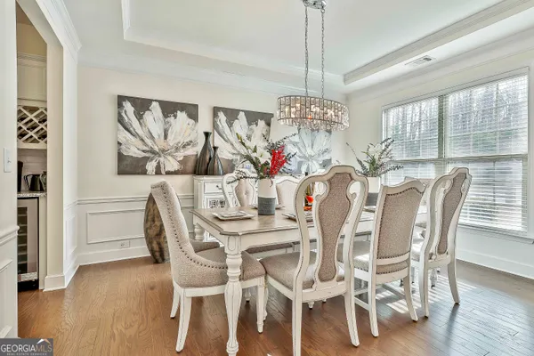 a view of a dining room with furniture and wooden floor