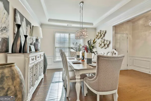a view of a dining room with furniture and chandelier