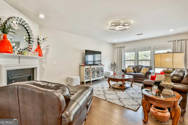 a living room with furniture fireplace and a window
