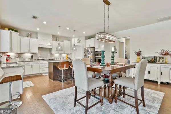 a kitchen with stainless steel appliances granite countertop a sink stove and cabinets
