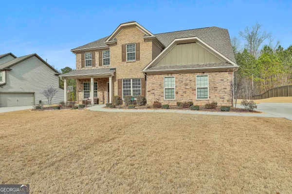 a front view of a house with a yard