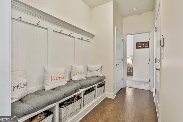 a bathroom with a sink a toilet a mirror and shower