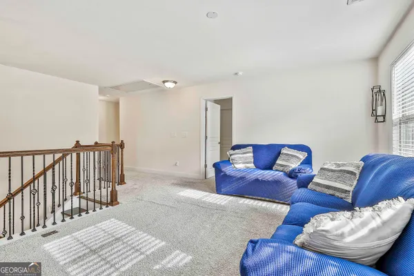 a bedroom with a bed and dresser with mirror