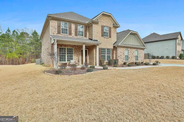 a front view of a house with a yard