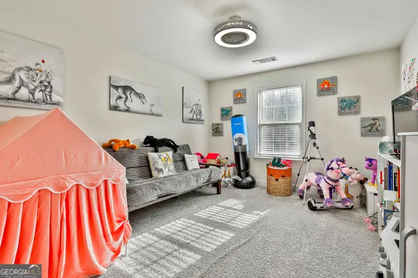 a bedroom with furniture a baby crib and a couch