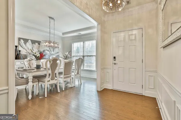 a view of a dining room with furniture wooden floor and chandelier