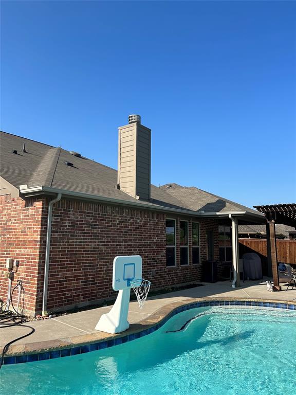 16117 Harper Road Prosper, TX 75078 - Photo 7 of 8 a front view of a house with a yard table and chairs
