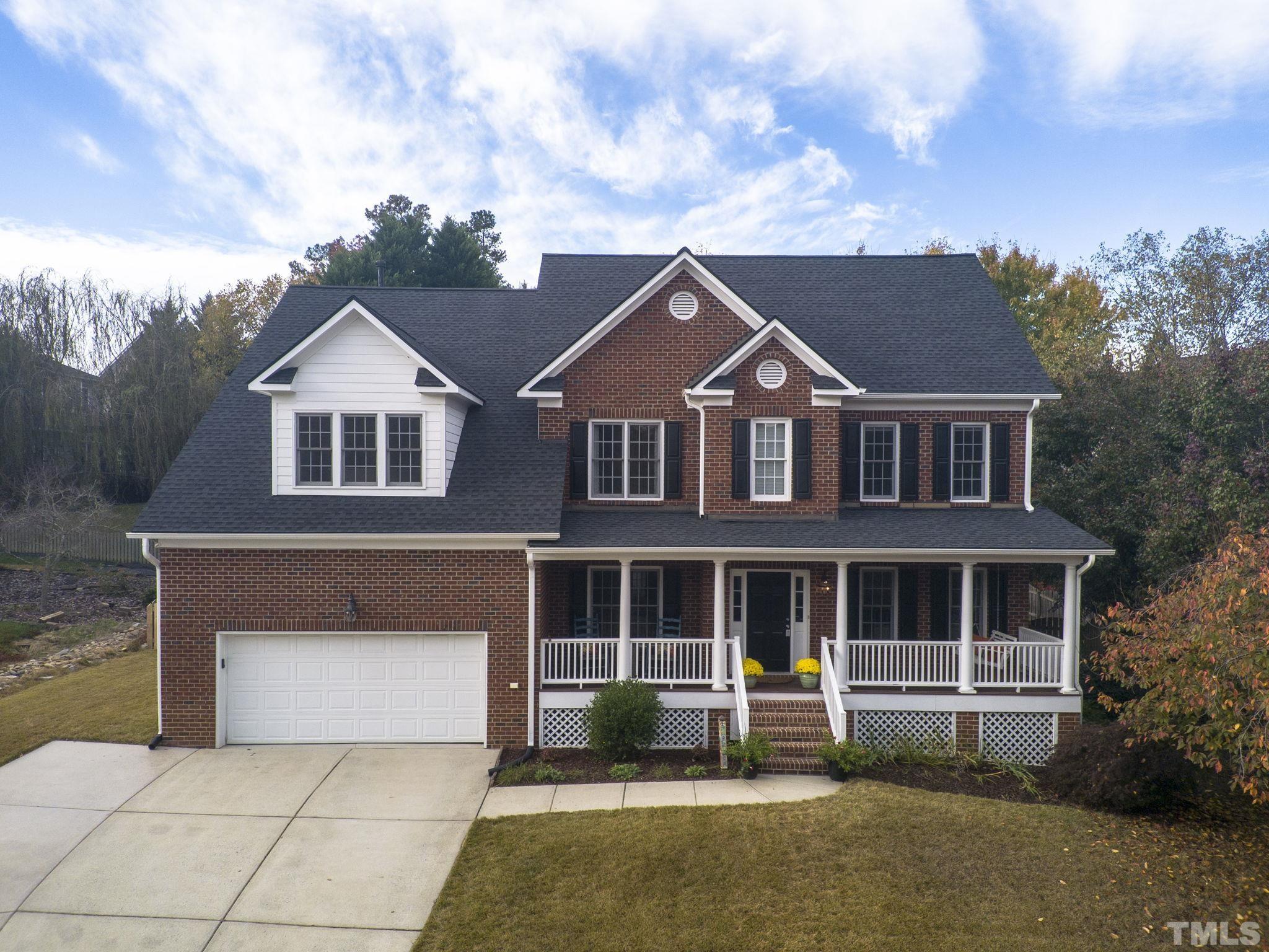 703 Haddon Hall Drive Apex, NC 27502 - Photo 1 of 49 a front view of a house with garden
