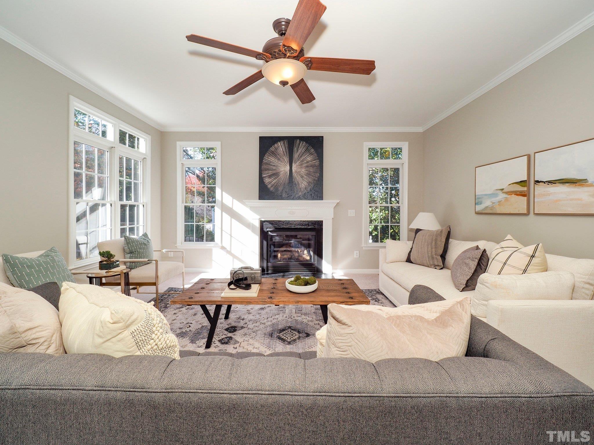 703 Haddon Hall Drive Apex, NC 27502 - Photo 11 of 49 a living room with furniture fireplace and a large window