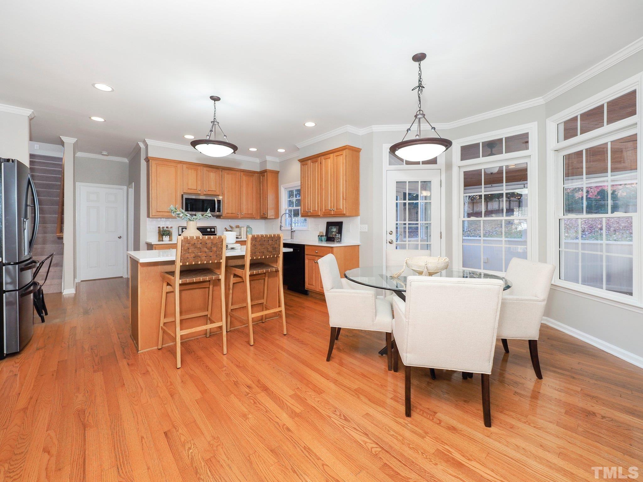 703 Haddon Hall Drive Apex, NC 27502 - Photo 12 of 49 a view of a dining room with furniture window and wooden floor