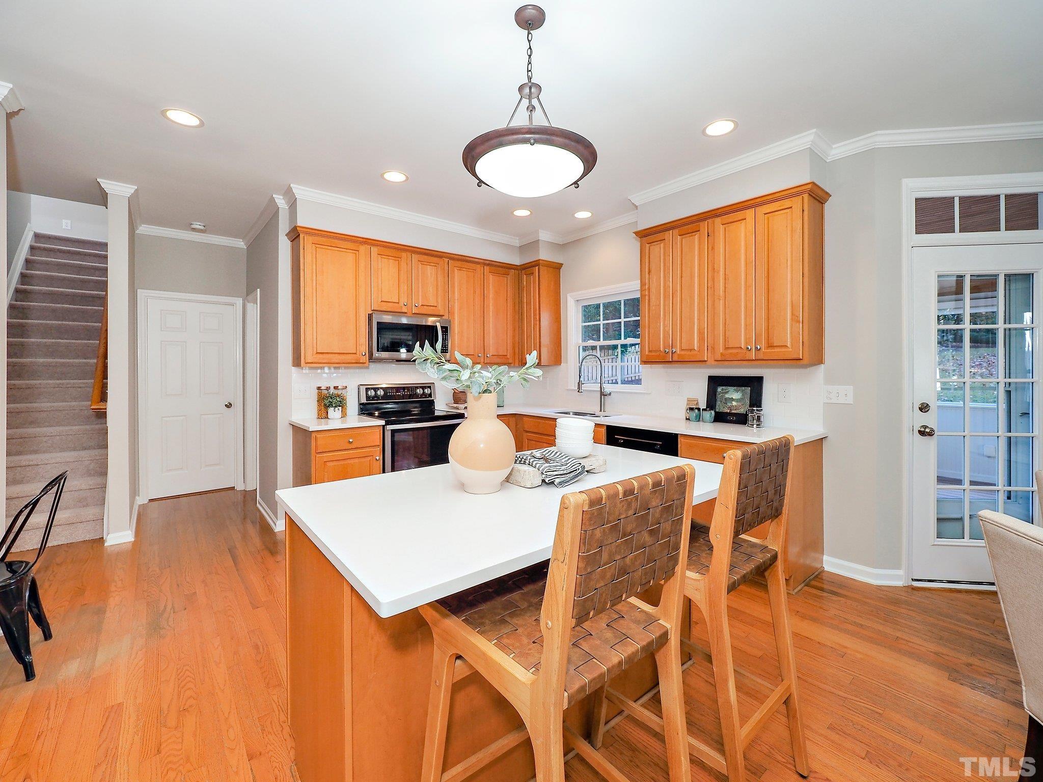 703 Haddon Hall Drive Apex, NC 27502 - Photo 14 of 49 a large kitchen with a table and chairs