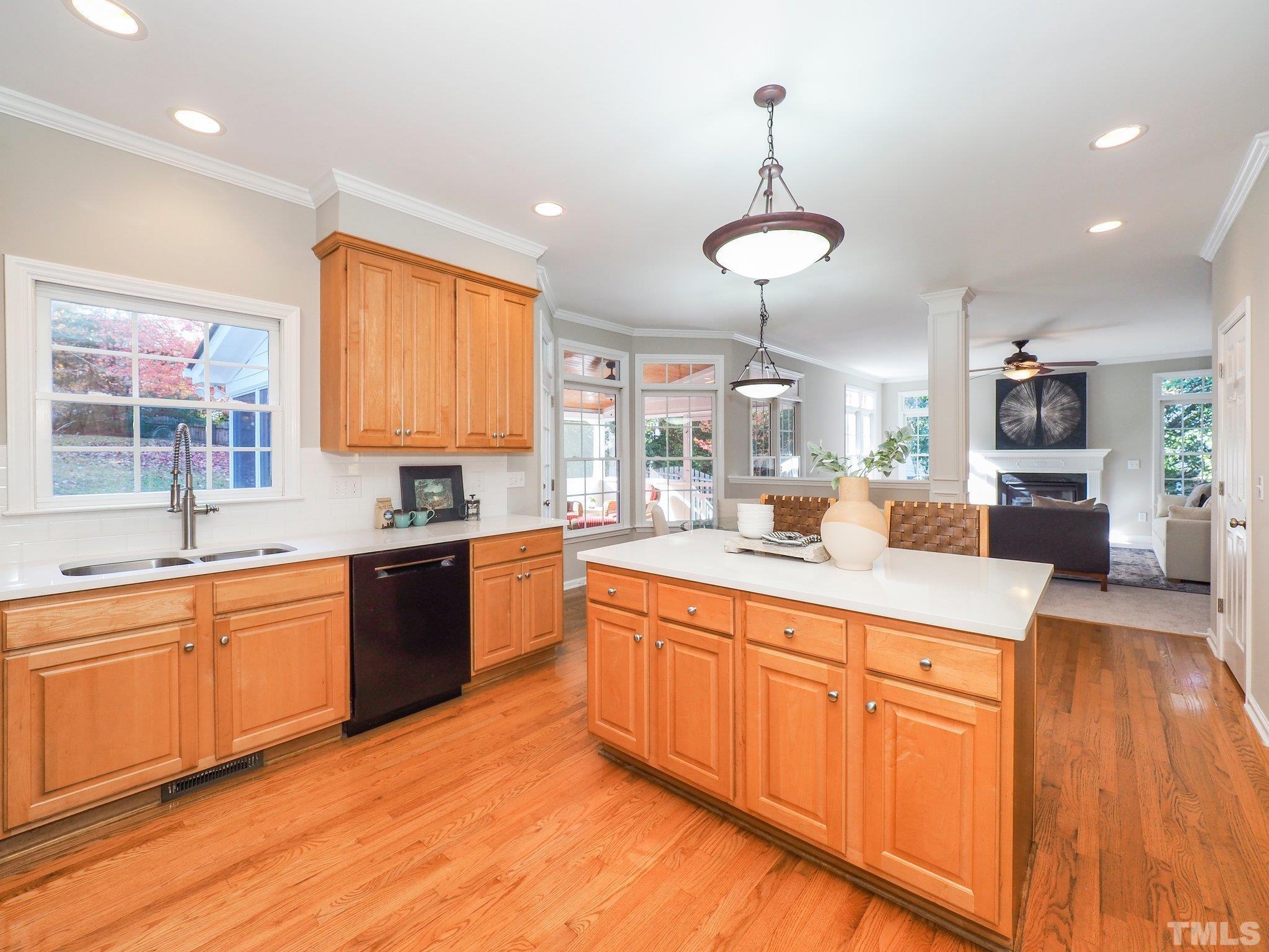 703 Haddon Hall Drive Apex, NC 27502 - Photo 16 of 49 a kitchen with stainless steel appliances granite countertop a sink dishwasher a stove and white countertops with wooden floor