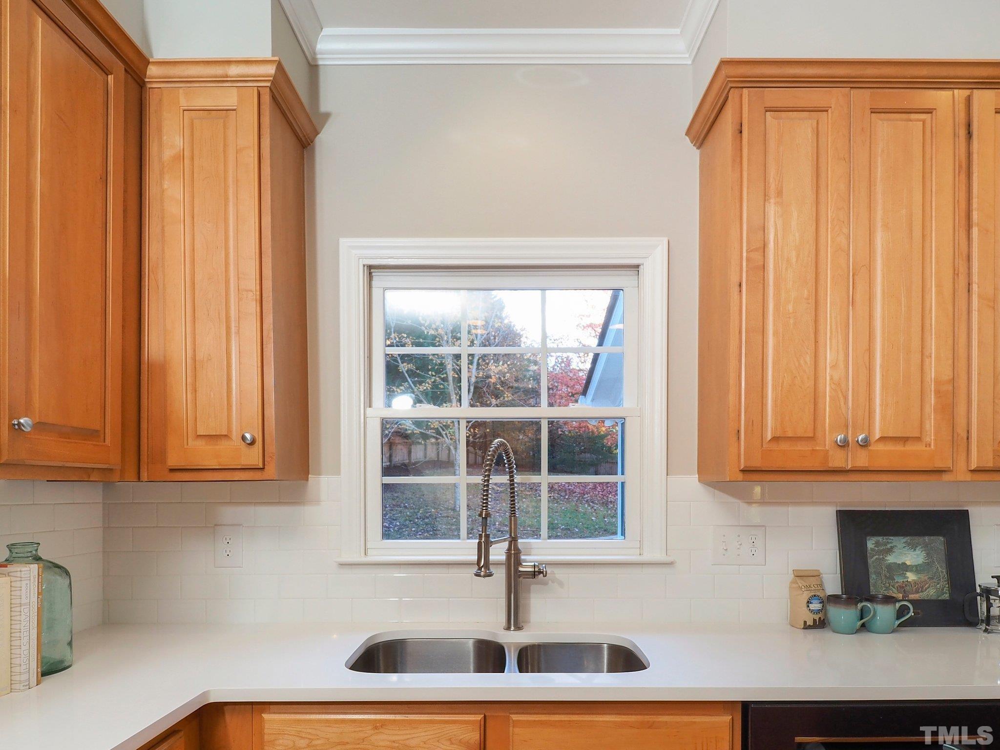 703 Haddon Hall Drive Apex, NC 27502 - Photo 17 of 49 a kitchen with stainless steel appliances a sink and a window