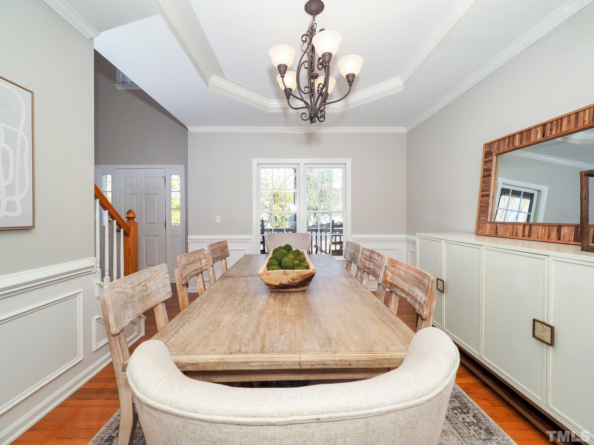 703 Haddon Hall Drive Apex, NC 27502 - Photo 19 of 49 a view of a dining room with furniture a chandelier and wooden floor