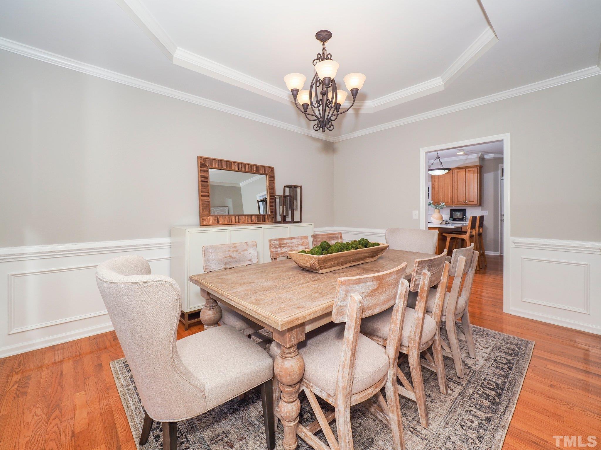 703 Haddon Hall Drive Apex, NC 27502 - Photo 20 of 49 a view of a dining room with furniture wooden floor and chandelier