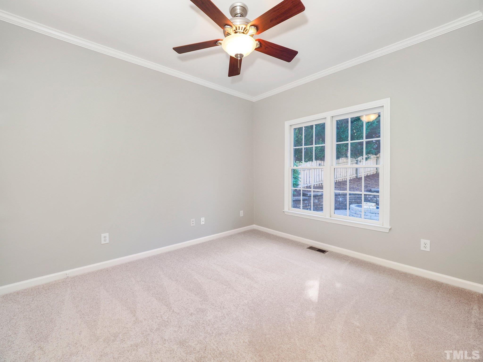 703 Haddon Hall Drive Apex, NC 27502 - Photo 22 of 49 an empty room with window and ceiling fan
