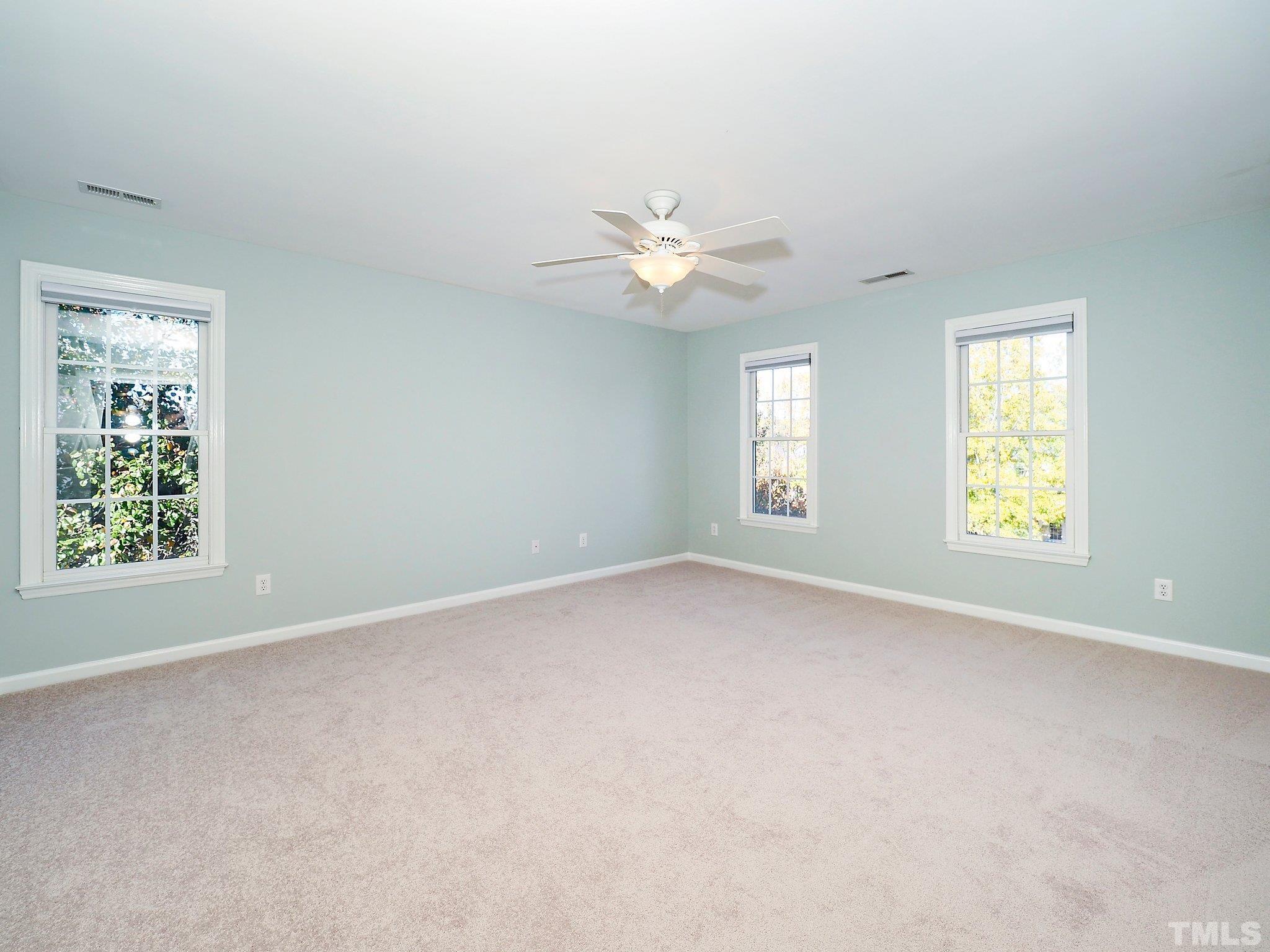 703 Haddon Hall Drive Apex, NC 27502 - Photo 26 of 49 an empty room with a window and a fan