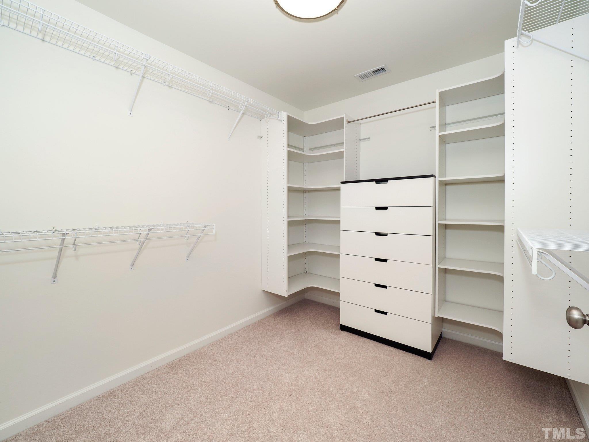 703 Haddon Hall Drive Apex, NC 27502 - Photo 29 of 49 a view of walk in closet with empty racks