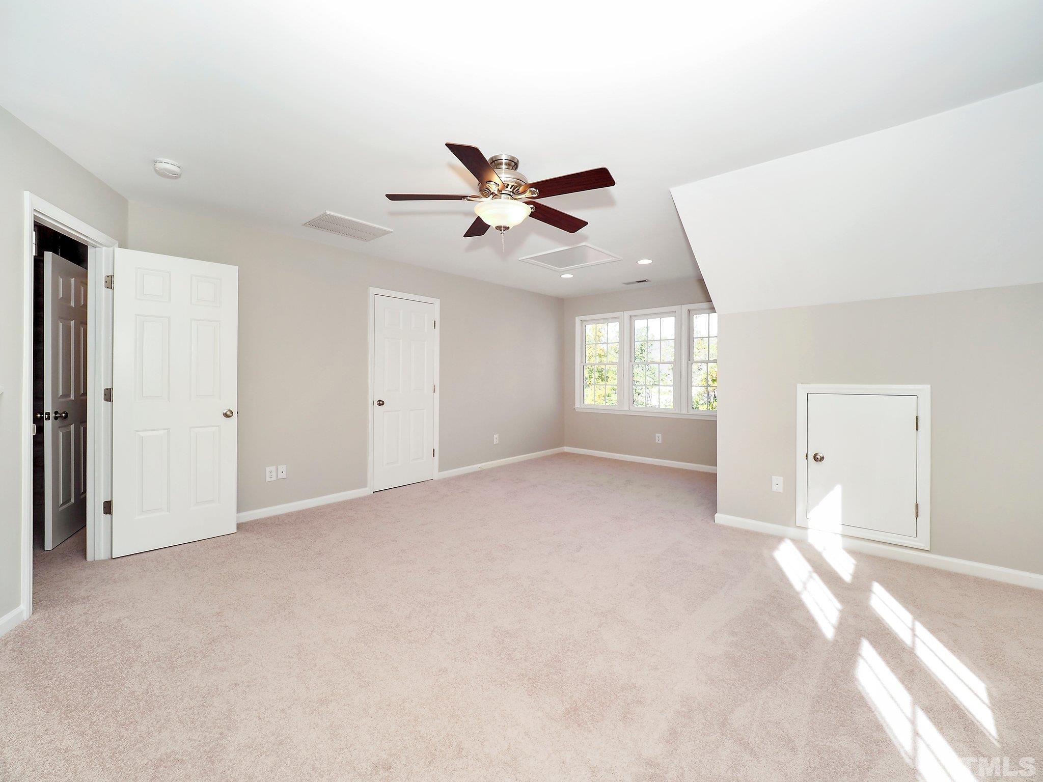 703 Haddon Hall Drive Apex, NC 27502 - Photo 34 of 49 a view of a livingroom with a ceiling fan and window