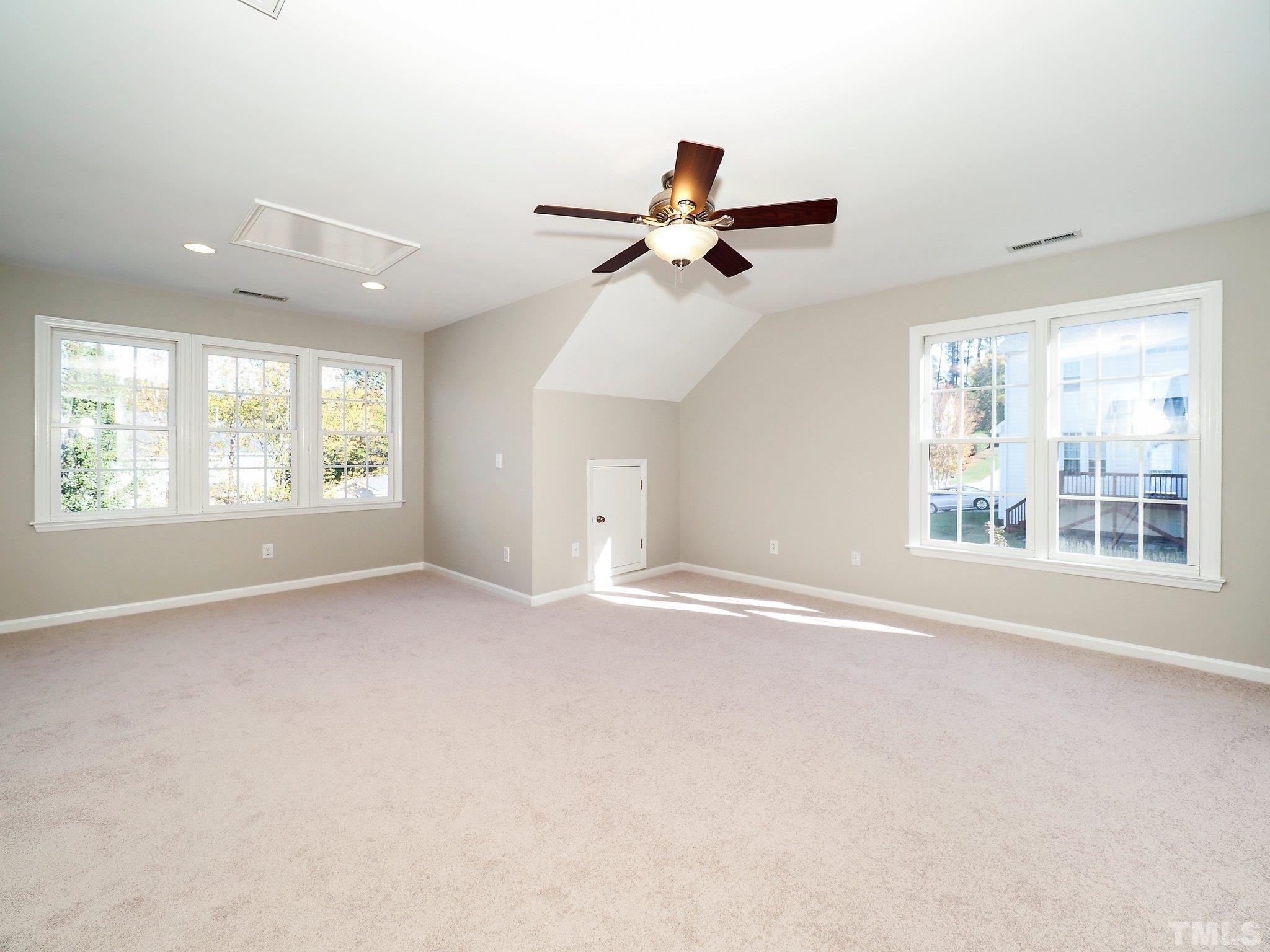703 Haddon Hall Drive Apex, NC 27502 - Photo 35 of 49 an empty room with windows and fan