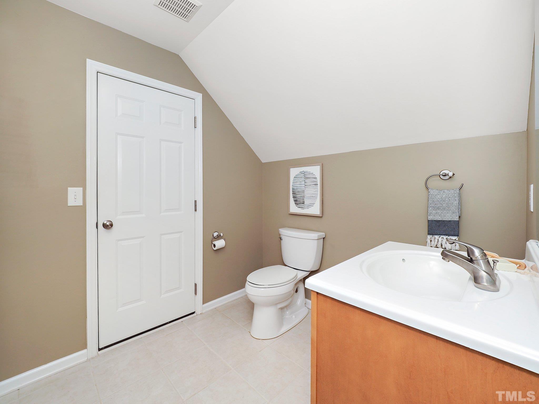 703 Haddon Hall Drive Apex, NC 27502 - Photo 39 of 49 a bathroom with a sink a toilet and a mirror