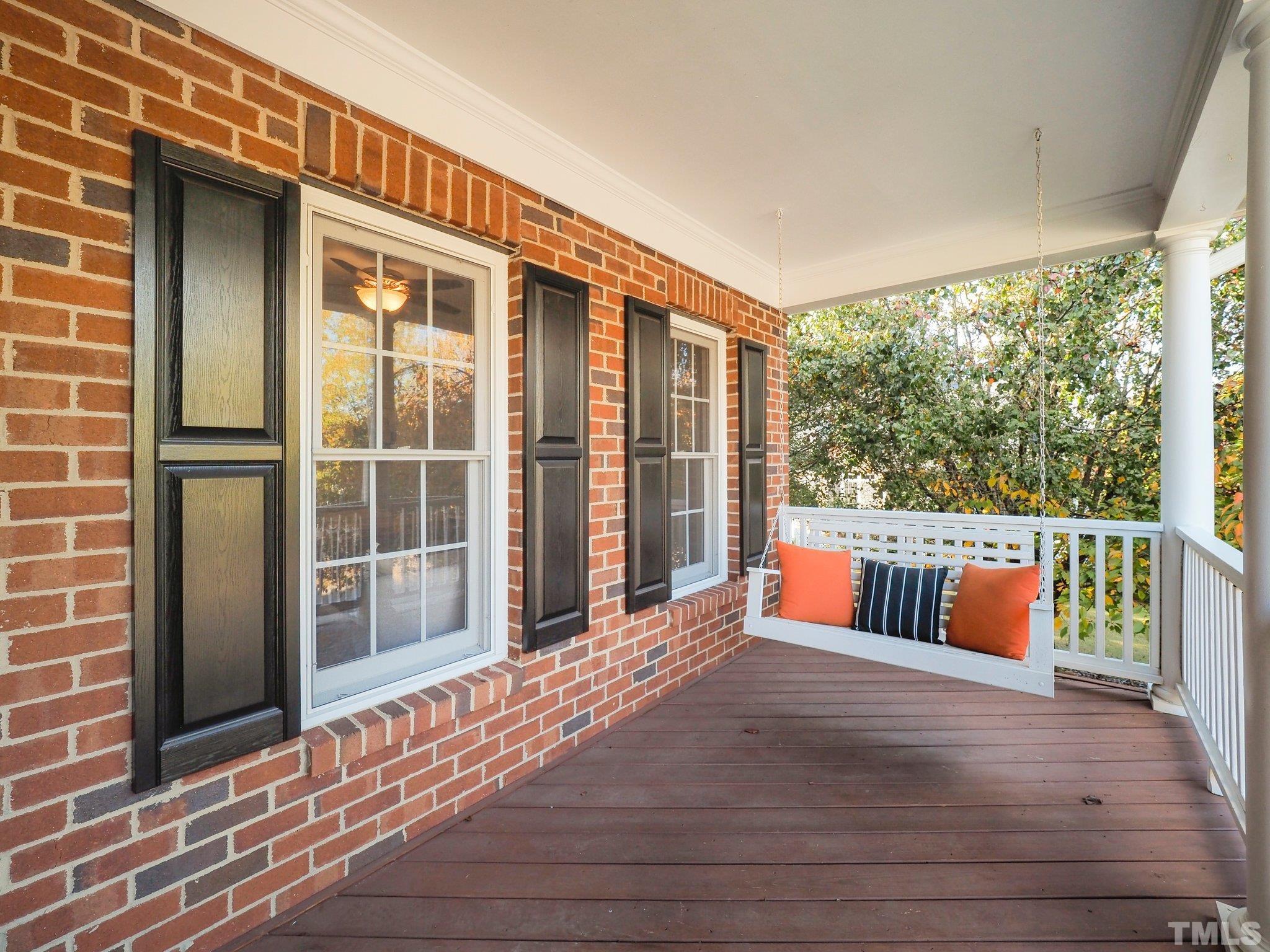 703 Haddon Hall Drive Apex, NC 27502 - Photo 6 of 49 a balcony with couch and wooden floor