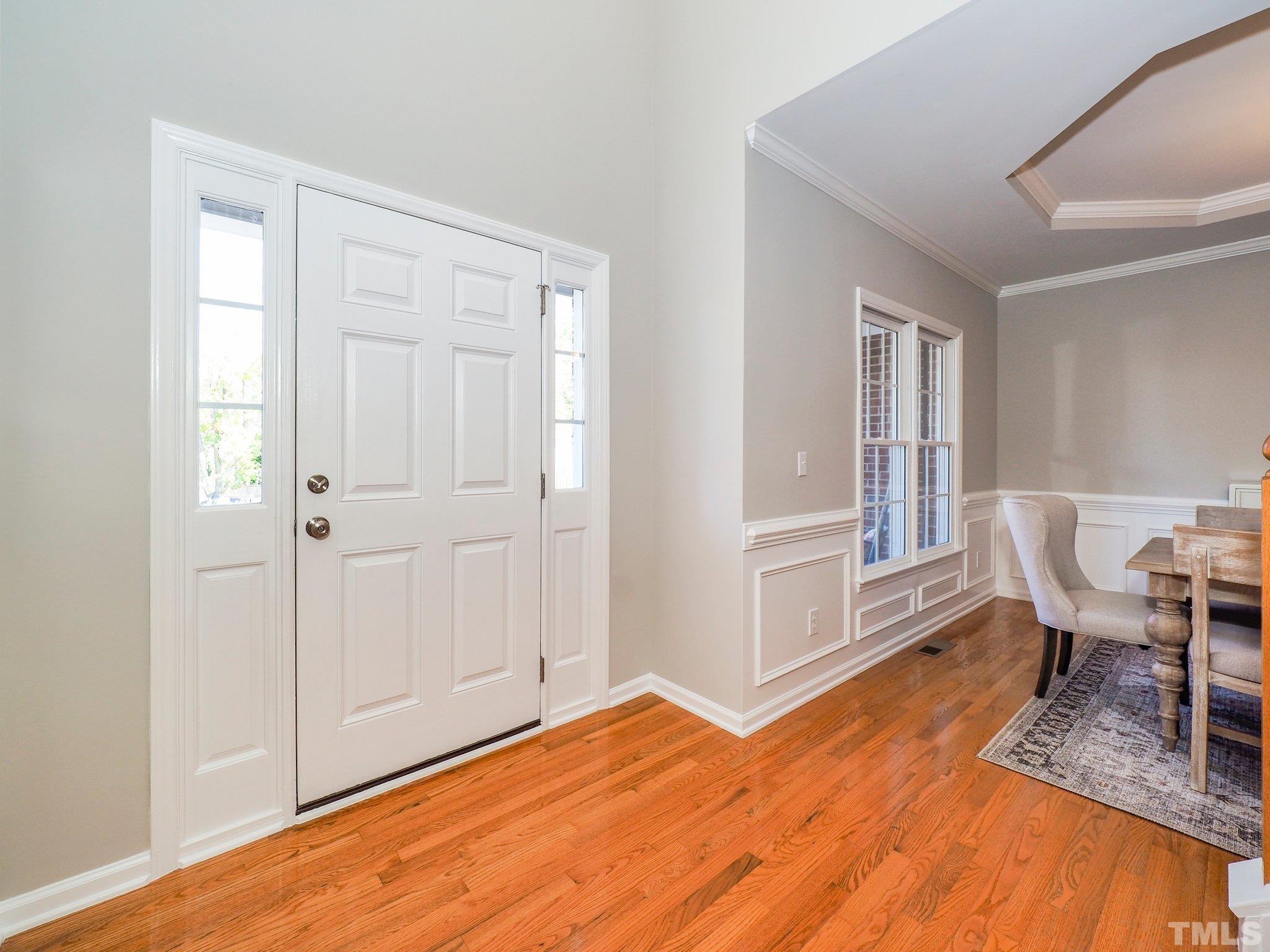 703 Haddon Hall Drive Apex, NC 27502 - Photo 7 of 49 a workspace with wooden floor and furniture