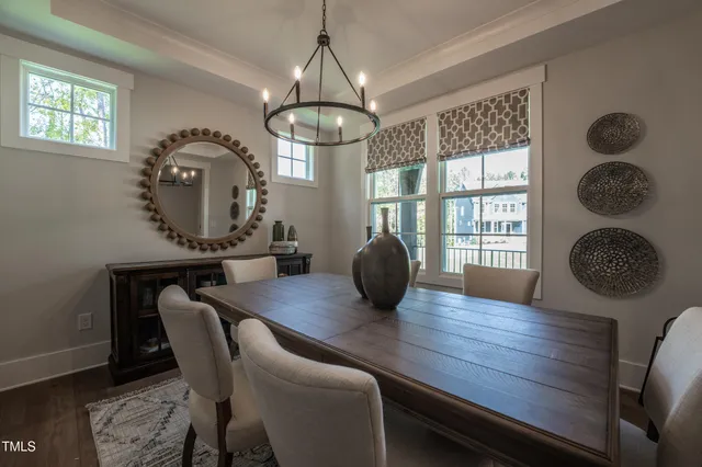 a view of a dining room with furniture wooden floor and chandelier