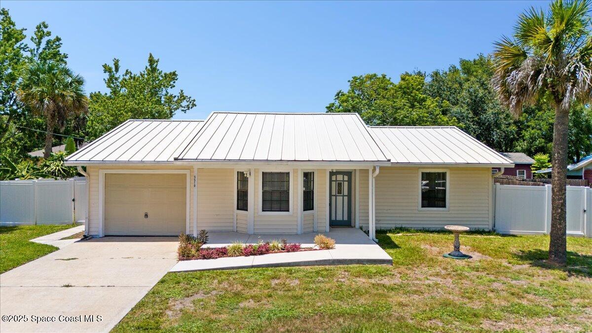 a front view of house with yard outdoor seating and barbeque oven