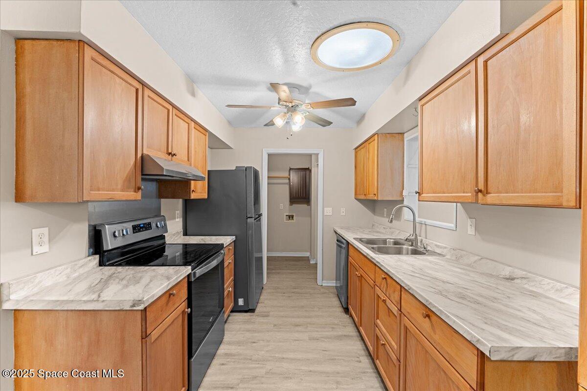 5510 Holden Road Cocoa, FL 32927 - Photo 12 of 51 a kitchen with stainless steel appliances granite countertop a stove a sink and a refrigerator