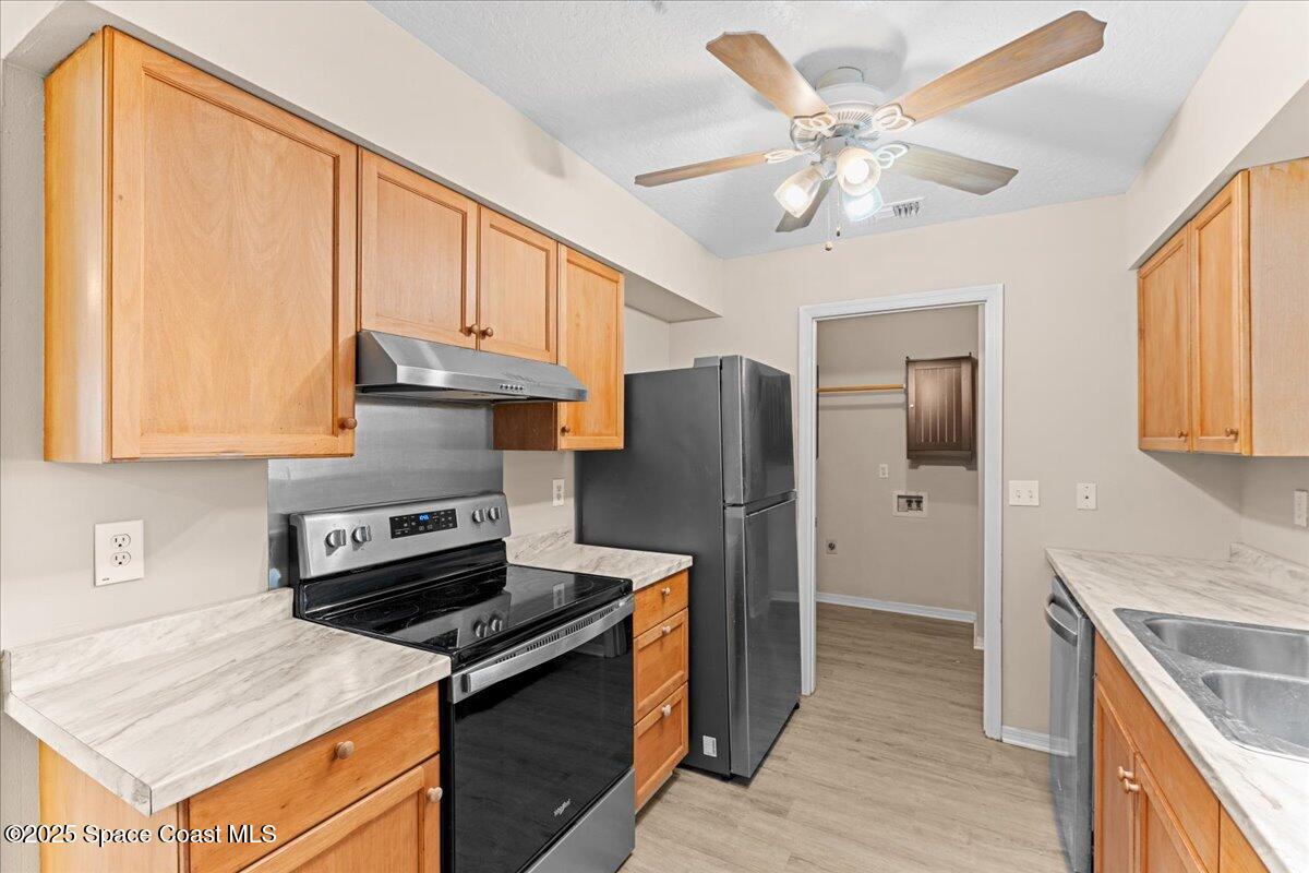 5510 Holden Road Cocoa, FL 32927 - Photo 13 of 51 a kitchen with stainless steel appliances granite countertop a stove refrigerator sink and cabinets
