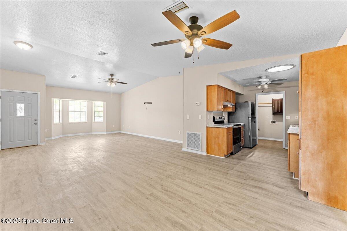 5510 Holden Road Cocoa, FL 32927 - Photo 16 of 51 a view of a kitchen with a sink hardwood floor and a large window