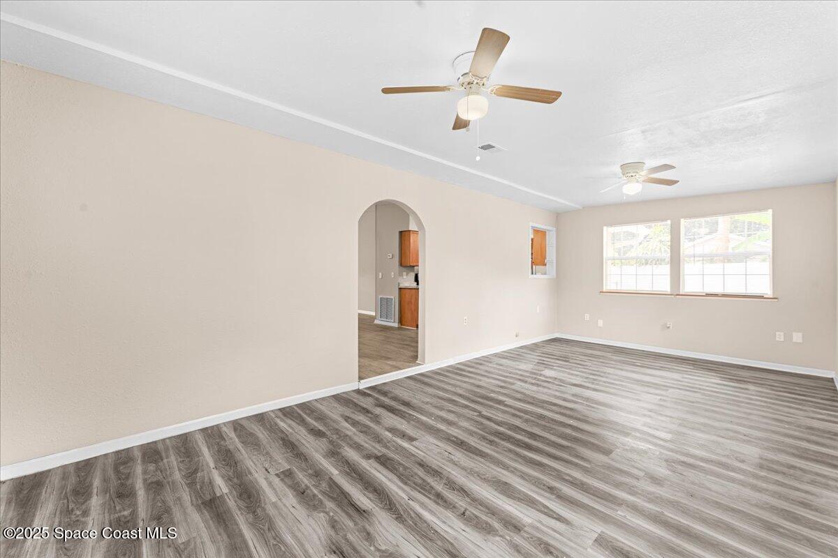 5510 Holden Road Cocoa, FL 32927 - Photo 18 of 51 wooden floor in an empty room with a window