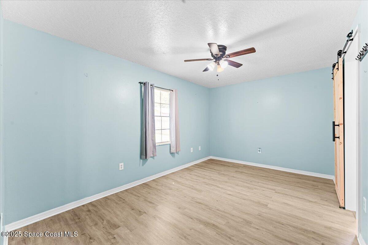 5510 Holden Road Cocoa, FL 32927 - Photo 20 of 51 wooden floor in an empty room with a window