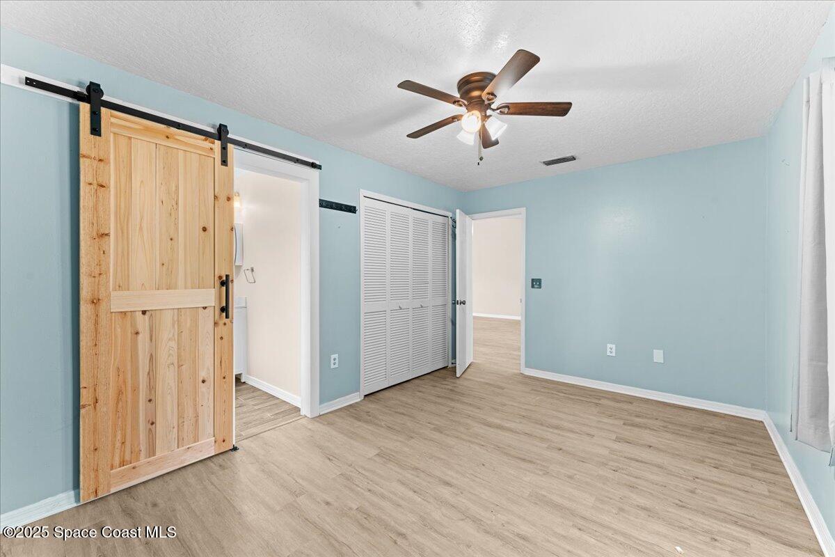 5510 Holden Road Cocoa, FL 32927 - Photo 21 of 51 a view of empty room with wooden floor and fan