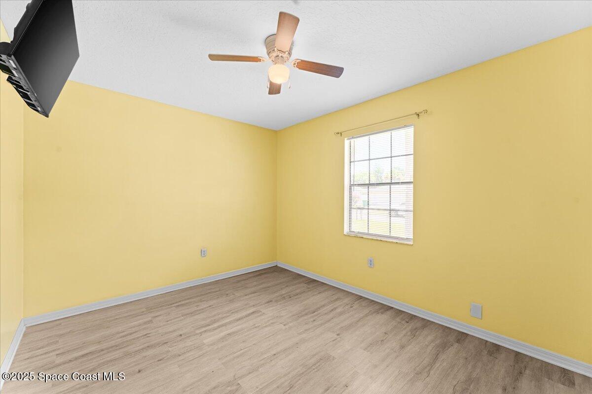 5510 Holden Road Cocoa, FL 32927 - Photo 25 of 51 a view of an empty room with wooden floor and a window