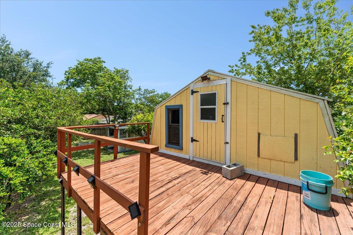 5510 Holden Road Cocoa, FL 32927 - Photo 33 of 51 a view of a house with backyard and deck