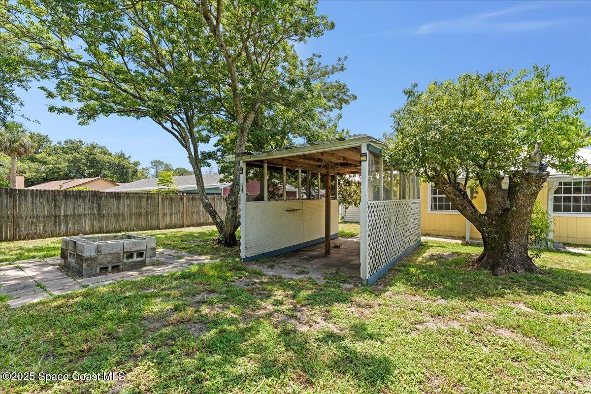 5510 Holden Road Cocoa, FL 32927 - Photo 38 of 51 a view of a backyard with a tree and a garden