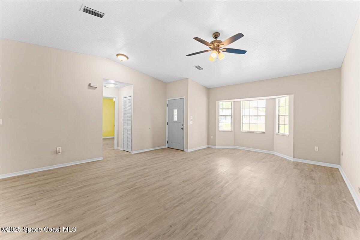 5510 Holden Road Cocoa, FL 32927 - Photo 5 of 51 a view of an empty room with window and wooden floor