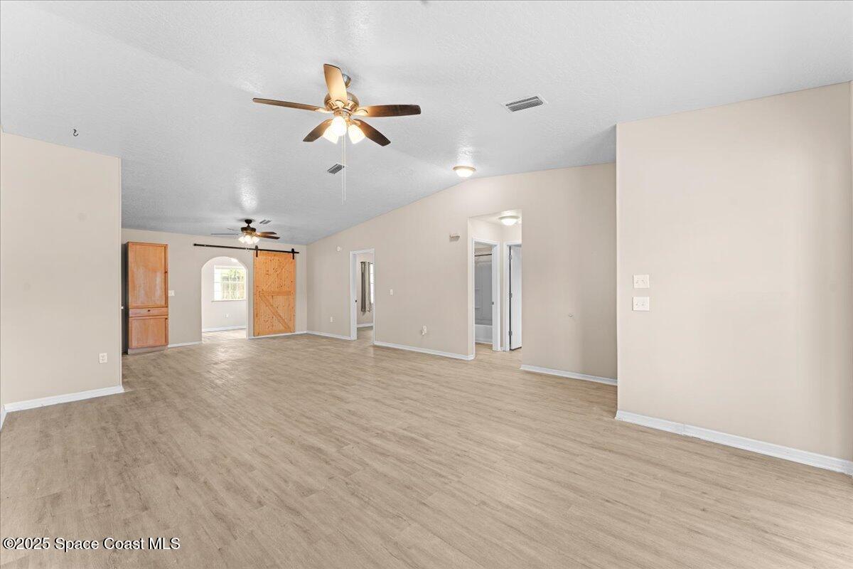 5510 Holden Road Cocoa, FL 32927 - Photo 6 of 51 a view of a room with wooden floor and ceiling fan