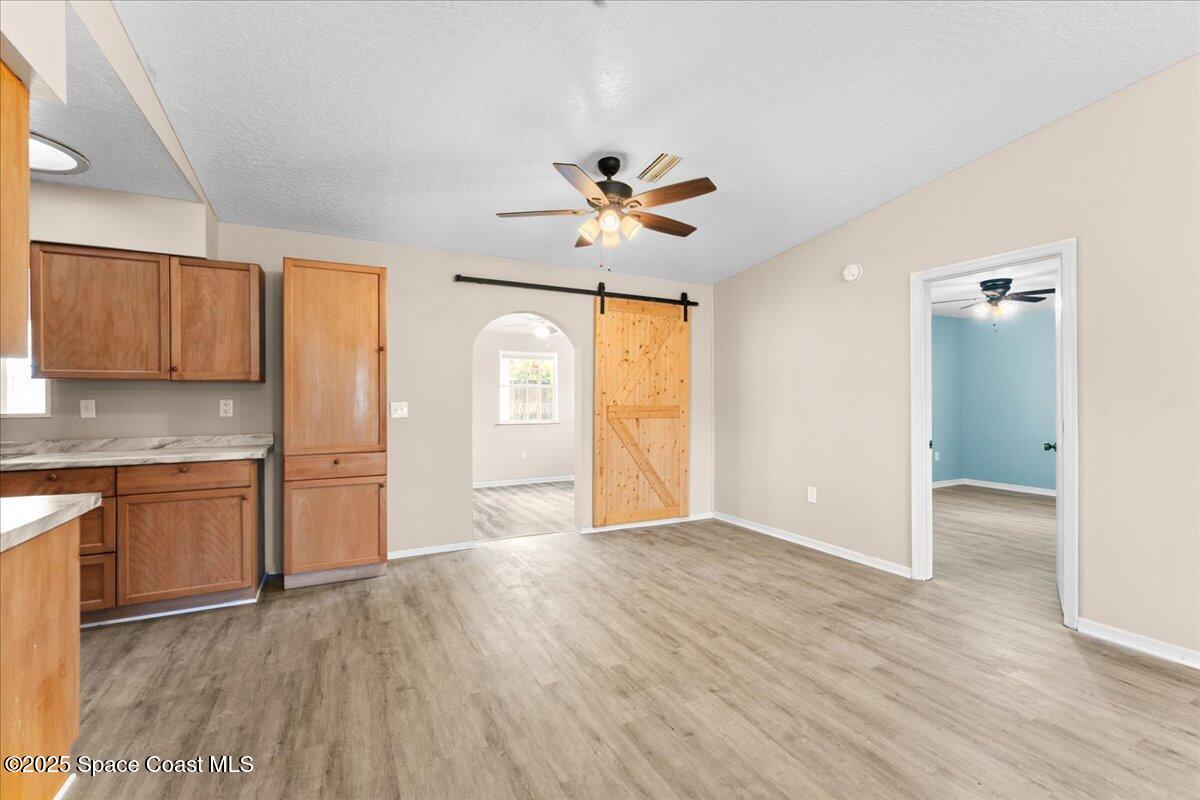 5510 Holden Road Cocoa, FL 32927 - Photo 9 of 51 a view of an empty room with window and wooden floor