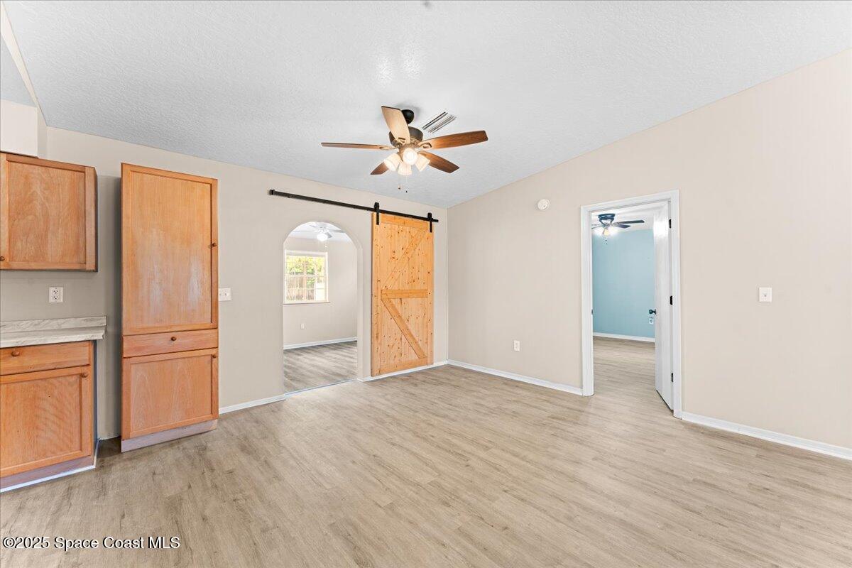5510 Holden Road Cocoa, FL 32927 - Photo 10 of 51 wooden floor in an empty room with a window