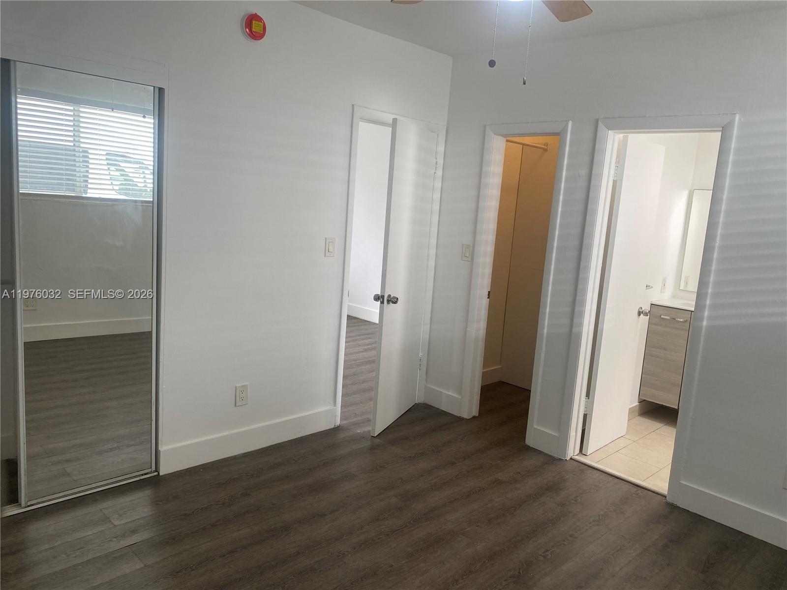 479 Southwest 3rd Street, Unit 4 Miami, FL 33130 - Photo 3 of 4 an empty room with wooden floor and a window