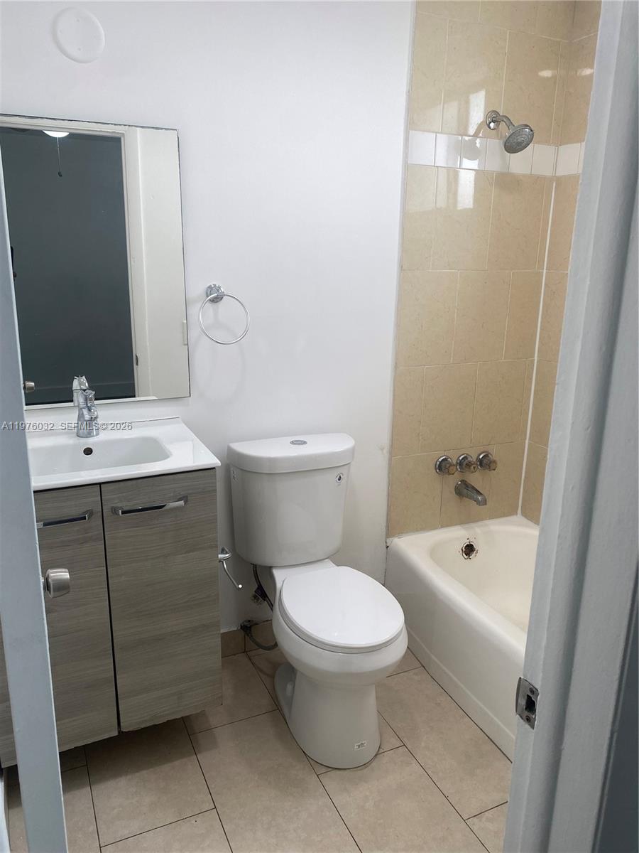 479 Southwest 3rd Street, Unit 4 Miami, FL 33130 - Photo 4 of 4 a bathroom with a sink a toilet and shower