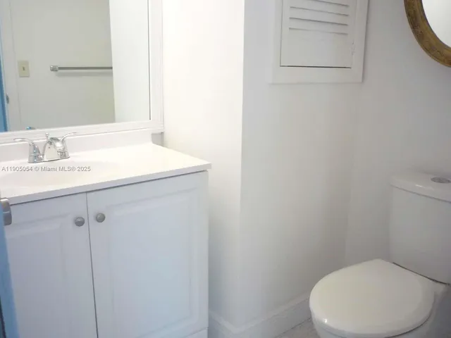 a white toilet sitting next to a bathroom sink